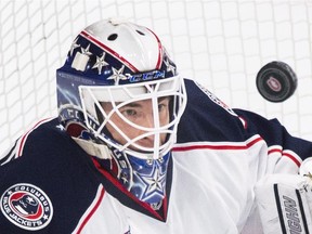Columbus Blue Jackets goaltender Curtis McElhinney keeps his eyes on the puck as he makes a save against the Canadiens during game at the Bell Centre on Feb. 21, 2015. The Canadiens won 3-1.