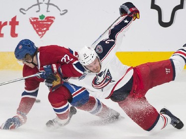 Montreal Canadiens' Dale Weise, left, collides with Columbus Blue Jackets' James Wisniewski during second period NHL hockey action in Montreal, Saturday, February 21, 2015.