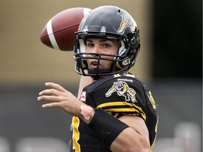 Hamilton Tiger-Cats quarterback Dan LeFevour makes a pass against the Calgary Stampeders during first half CFL football action in Hamilton, Ont., on Saturday, August 16, 2014.
