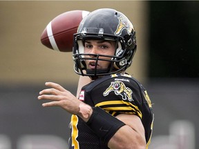 Hamilton Tiger-Cats quarterback Dan LeFevour makes a pass against the Calgary Stampeders during first half CFL football action in Hamilton, Ont., on Saturday, August 16, 2014. The Montreal Alouettes signed the free-agent quarterback to a one-year contract Wednesday.