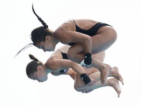 Canada's Roseline Filion (right) and Meaghan Benfeito dive during the women's 10-metre synchro final at the 19th FINA Diving World Cup in Shanghai on July 17, 2014.