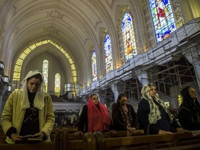 Egyptian Coptic women attend a mass led by Egypt's Coptic Pope Tawadros II to honor the memory of the Egyptian Coptic Christians murdered by Islamic State (IS) group militants in Libya on February 17, 2015 at Saint-Mark's Coptic Cathedral in Cairo's al-Abbassiya district. Egypt called for a UN-backed international intervention in Libya after launching air strikes on Islamic State group targets in the country following the jihadists' beheadings of the Egyptian Coptic Christians on a Libyan beach.