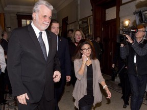 Ensaf Haider, right, wife of Raif Badawi, walks with Quebec Premier Philippe Couillard, left, to his office, after the legislature voted unanimously in favour of a motion to free her husband from a Saudi Arabia jail, Wednesday, Feb. 11, 2015 at the legislature in Quebec City.