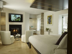 The two-level suite at Hôtel Le Priori in Old Quebec has a wood fireplace and a private hot tub on the balcony.