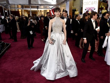 Felicity Jones arrives at the Oscars on Sunday, Feb. 22, 2015, at the Dolby Theatre in Los Angeles.