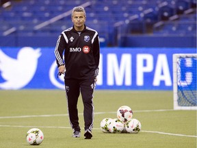 Montreal Impact head coach Frank Klopas walks on the field to start practice as the team opens its pre-season training camp at Olympic Stadium Friday, January 23, 2015 in Montreal.