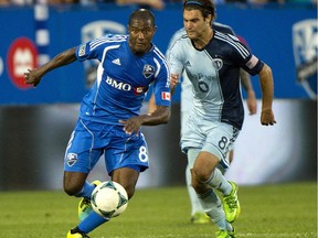 The Impact's Patrice Bernier breaks away from Sporting Kansas City's Graham Zusi during MLS action in Montreal on July 27, 2013.