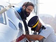 Chiheb Esseghaier, one of two men accused of plotting a terror attack on a Via Rail train, is led off a plane by an RCMP officer at Buttonville Airport just north of Toronto in April 2013.