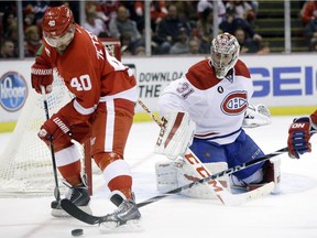 Montreal Canadiens goalie Carey Price (31) watches as Detroit Red Wings left wing Henrik Zetterberg (40) of Sweden controls the puck during the second period of an NHL hockey game Monday, Feb. 16, 2015, in Detroit.
