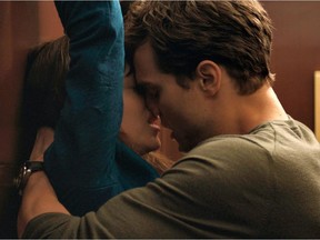In this image released by Universal Pictures and Focus Features, Dakota Johnson, left, and Jamie Dornan appear in a scene from "Fifty Shades of Grey."