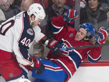 Montreal Canadiens' Christian Thomas, right, collides with Columbus Blue Jackets' Jared Boll during first period NHL hockey action in Montreal, Saturday, February 21, 2015.