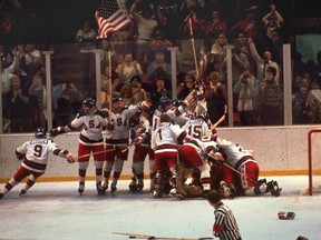 In this Feb. 22, 1980 file photo, the U.S. hockey team pounces on goalie Jim Craig after a 4-3 victory against the Soviets at the Winter Olympic Games in Lake Placid, N.Y.