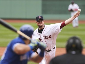 Boston Red Sox pitcher Jon Lester delivers to the Toronto Blue Jays' Melky Cabrera during game at Fenway Park on May 22, 2014.