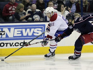 Montreal Canadiens' Lars Eller, left, of Denmark, carries the puck up ice as Columbus Blue Jackets' Fedor Tyutin, of Russia, defends during the first period of an NHL hockey game Thursday, Feb. 26, 2015, in Columbus, Ohio.