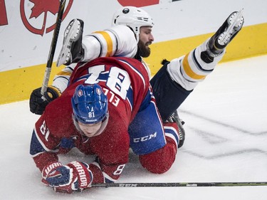 Buffalo Sabres' Mike Weber falls over Montreal Canadiens' Lars Eller during first period NHL hockey action Tuesday, February 3, 2015 in Montreal.