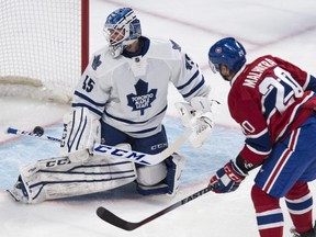 Montreal Canadiens' Manny Malhotra scores past Toronto Maple Leafs goalie Jonathan Bernier during first period NHL hockey action Saturday, February 28, 2015 in Montreal.
