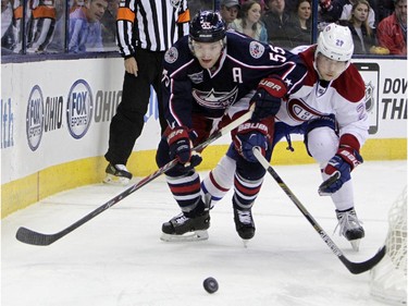 Columbus Blue Jackets' Mark Letestu, left, and Montreal Canadiens' Nathan Beaulieu chase a loose puck during the second period of an NHL hockey game Thursday, Feb. 26, 2015, in Columbus, Ohio.