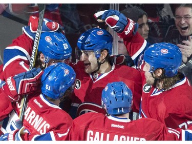 Montreal Canadiens' Max Pacioretty (67) celebrates with teammates Nathan Beaulieu (28), David Desharnais (51), Brendan Gallagher (11) and Tom Gilbert after scoring against the Columbus Blue Jackets during first period NHL hockey action in Montreal, Saturday, February 21, 2015.