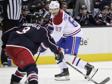 Montreal Canadiens' Max Pacioretty, right, looks for an open pass as Columbus Blue Jackets' Jordan Leopold defends during the third period of an NHL hockey game Thursday, Feb. 26, 2015, in Columbus, Ohio. The Canadiens won 5-2.