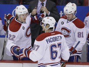 Montreal Canadiens left wing Max Pacioretty is congratulated after his empty-net goal during the third period of an NHL hockey game against the Detroit Red Wings, Monday, Feb. 16, 2015, in Detroit. Montreal won 2-0.