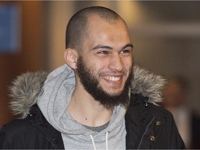 Merouane Ghalmi smiles as he arrives at the Montreal Courthouse in Montreal, Thursday, February 26, 2015. Ghalmi was in court Friday after being arrested for violating the conditions of a peace bond.