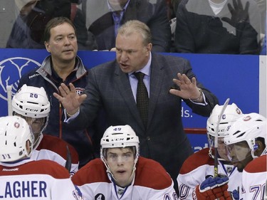 Montreal Canadiens head coach Michel Therrien talks to his team during the third period of an NHL hockey game against the Detroit Red Wings, Monday, Feb. 16, 2015, in Detroit. Montreal won 2-0.