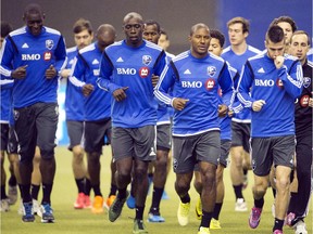 Montreal Impact players run around the field on first day of training camp at Olympic Stadium on Jan. 23, 2015