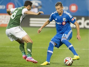 The Impact's Krzysztof Krol controls the ball in front of the Portland Timbers' Diego Valeri during MLS game in Montreal on July 27, 2014.