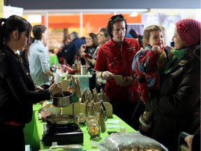 Two year old Raphaïlle and her mother, Nathalie Bastien (right), sample food at the Montréal en lumière festival in the Jean Talon Market in 2013. The public is invited to sample a variety of products at the market this weekend.