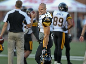 Hamilton Tiger-Cats receiver Samuel Giguère jokes with Quebec-born members of the Alouettes before CFL game at Montreal's Molson Stadium on Aug. 23, 2012.