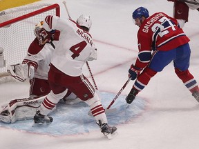 Canadiens' Alex Galchenyuk scores on Arizona Coyotes goalie Louis Domingue, while Coyotes' Zbynek Michalek comes in late on the play, during first period NHL action in Montreal on Sunday February 01, 2015.