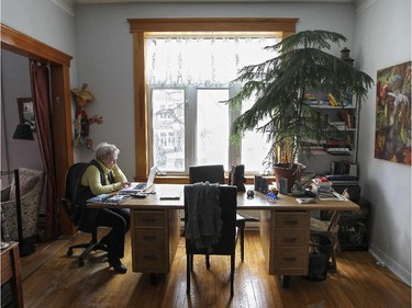 Raymonde Letourneau sits at a large desk in the living room of her home in Outremont.