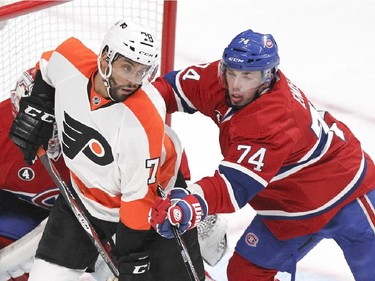 Montreal Canadiens defenceman Alexei Emelin, right, checks Philadelphia Flyers Pierre-Edouard Bellemare in the back during second period of National Hockey League game in Montreal Tuesday February 10, 2015.