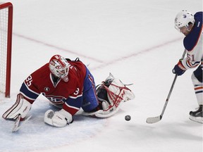 MONTREAL, QUE.: February 12, 2015 --  Edmonton Oilers Anton Lander scores winning goal past Montreal Canadiens goalie Dustin Tokarski during overtime of National Hockey League game in Montreal Thursday February 12, 2015. (John Mahoney / MONTREAL GAZETTE)