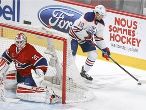 Edmonton Oilers' Nail Yakupov controls the puck behind Montreal Canadiens goalie Dustin Tokarski during the first period on Thursday at the Bell Centre.