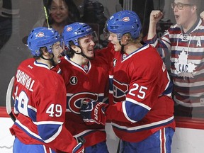 Montreal Canadiens Christian Thomas, centre, celebrates his first career NHL goal with team-mates Michael Bournival and Jacob De La Rose Edmonton during the first period.