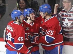 Montreal Canadiens Christian Thomas, centre, celebrates his first career NHL goal with teammates Michael Bournival and Jacob De La Rose during first-period play against the Edmonton Oilers at the Bell Centre on  Thursday.