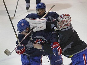 Canadiens goalie Carey Price engages in some playful fighting with teammates Nathan Beaulieu and P.K. Subban at the end of practice at the Bell Sports Complex in Brossard on Feb. 13, 2015.