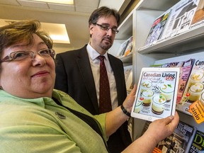 Lise Brosseau and François Pominville, both of the Dollard Public Library check out Canadian Living in Dollard-des-Ormeaux, on Friday, February 13, 2015. The library currently has 36 digital editions of popular magazines available to local residents to go along with other online services such as e-books.