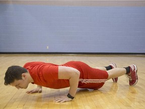 Mathieu Lepage does a pushup at  Sir Arthur Currie Gym in  Montreal.