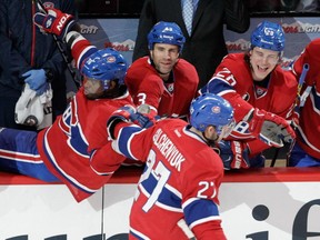 Alex Galchenyuk of the Montreal Canadiens is congratulated by teammates, from the left: P.K. Subban, Mike Weaverand Nathan Beaulieu after he scored against Jonathan Bernier of theToronto Maple Leafs in the shootout section of an NHL game at the Bell Centre in  Montreal on Saturday, February 14, 2015.