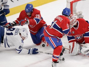 P.K. Subban  of the Montreal Canadiens tries to keep Phil Kessel of the Toronto Maple Leafs from scoring  in the overtime period of an NHL game at the Bell Centre in Montreal on Saturday, February 14, 2015. On the right are David Desharnais and goalie Carey Price.