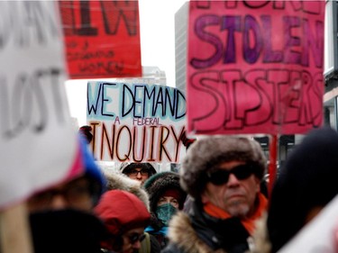 Protesters take part in the Memorial March for Missing and Murdered Women in Montreal on Saturday, February 14, 2015.