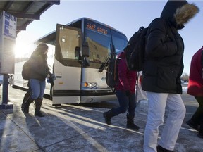 Train commuters from the Vaudreuil train station exit a shuttle bus at the Côte-Vertu métro Feb. 16, 2015.