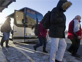 Regular train commuters from the Vaudreuil train station exit a shuttle bus at the Côte Vertu métro station on Monday, Feb.16, 2015.  Rail services on commuter lines were suspended because of a strike by more than 3,000 members of the Teamsters against Canadian Pacific Railway.