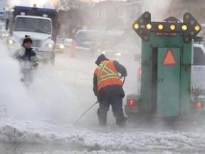 City crews clean up ice on Provost St. at 7th Ave., following a water main break in Lachine Feb. 17, 2015.