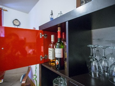 The liquor is kept behind the red door in their shelving unit.