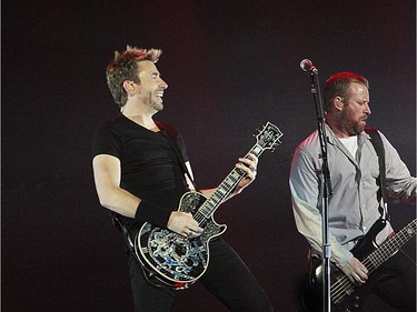 Lead singer Chad Kroeger, left, of Nickelback performs on stage at the Bell Centre on February 18, 2015 in Montreal. Right is Mike Kroeger, the bass guitar player.