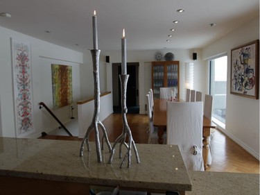 A view from the kitchen to the dining room area in the home of Anne Darche at the Habitat 67 complex in Montreal. In the foreground are silver branch candlesticks by American desiger Michael Aram.