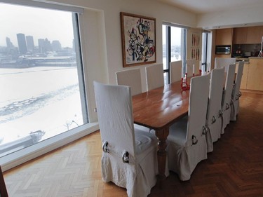 A view of the dining room at the Habitat 67 complex. On the wall is a work by artist Carlito Dalceggio above an antique Quebec pine refectory table.
